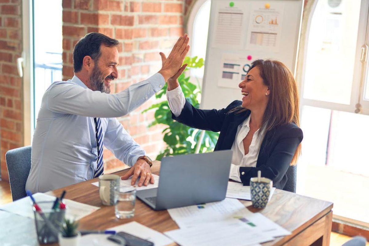 business people celebrate with a high five